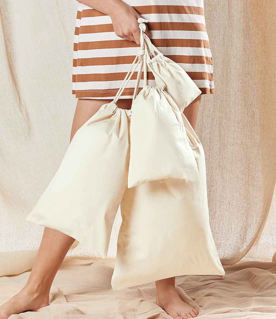 model holding Westford Mill Organic Premium Cotton Stuff Bags