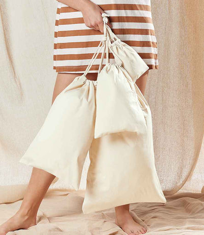 model holding Westford Mill Organic Premium Cotton Stuff Bags